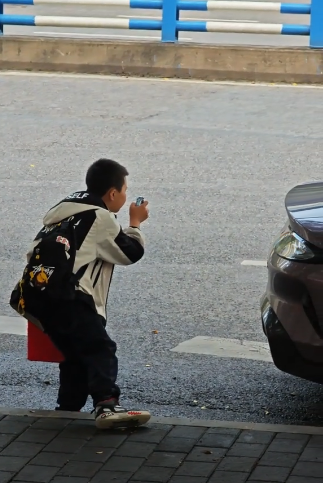 小米SU7成街头最靓的仔 吸引小学生用儿童手表拍照